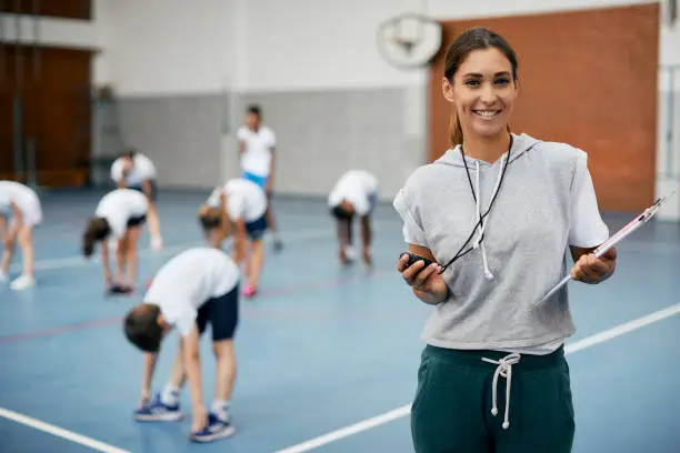 portrait of happy female physical education teacher at schoo